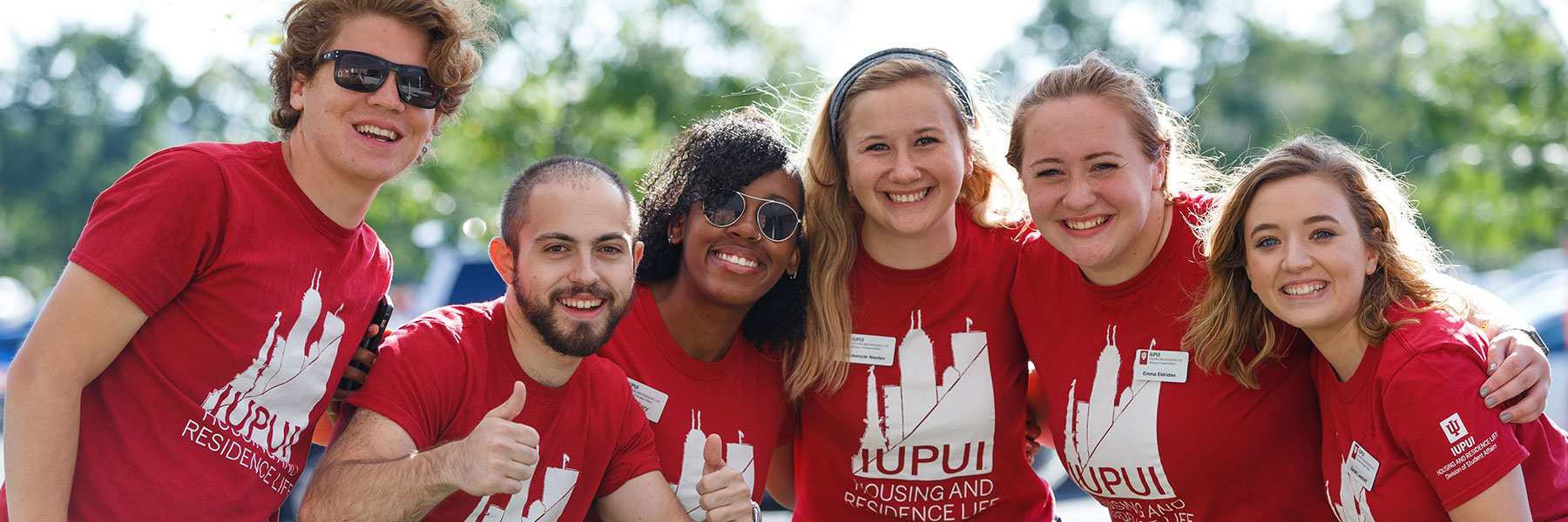 Students that work in housing pose for a picture on move in day.