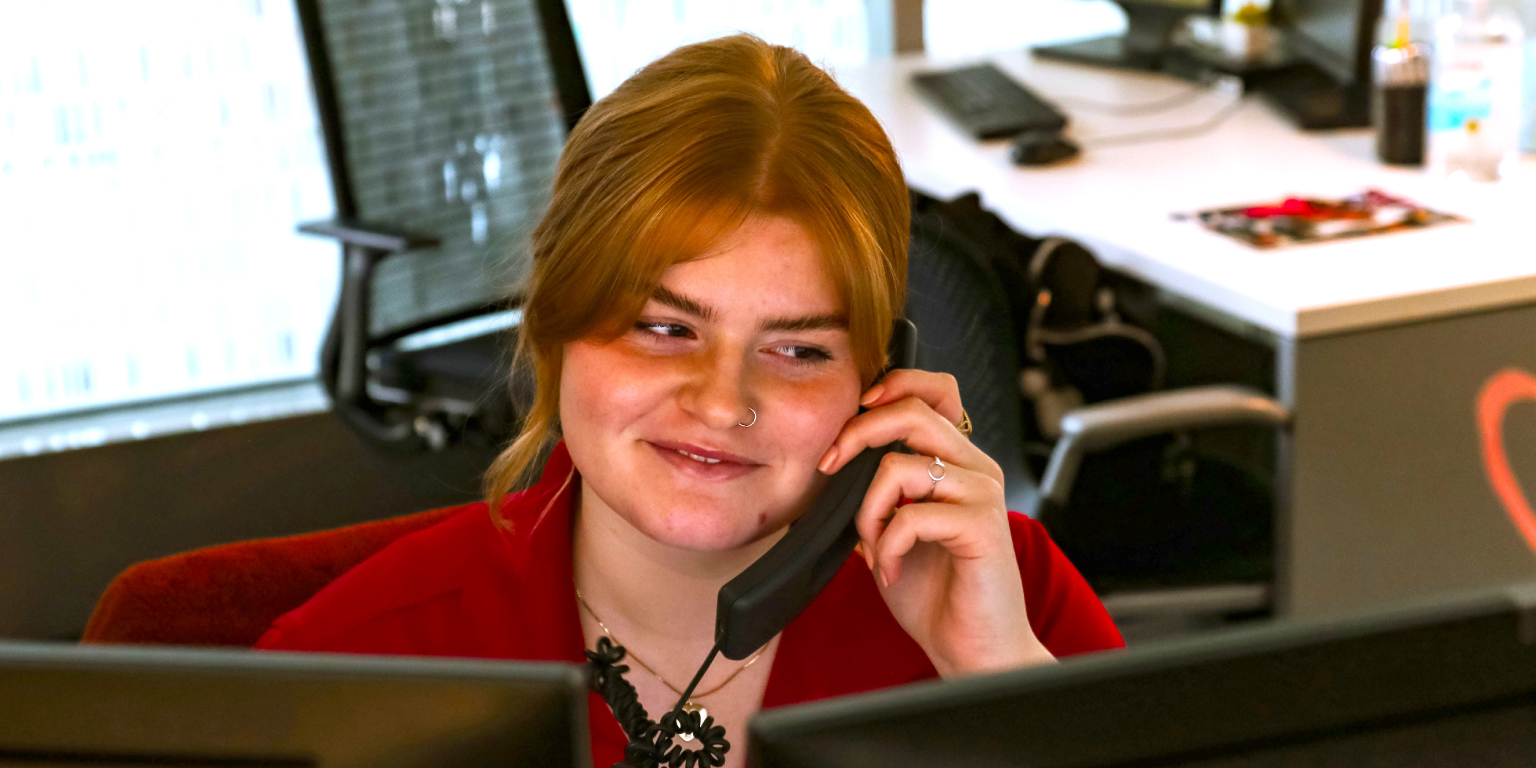 Student employee working in the CUBE answers the phone.