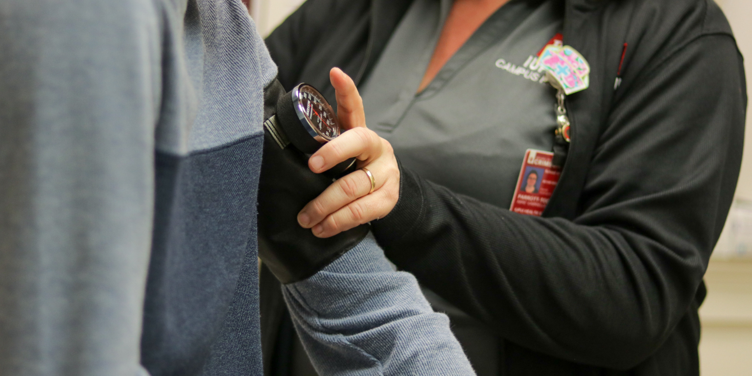 A student gets their blood pressure taken at Campus Health.
