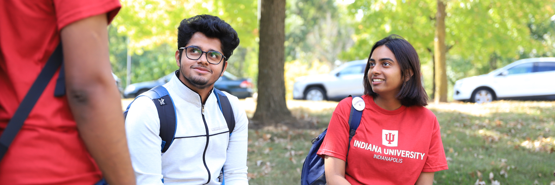 Students hanging out in the green space at Riverwalk.